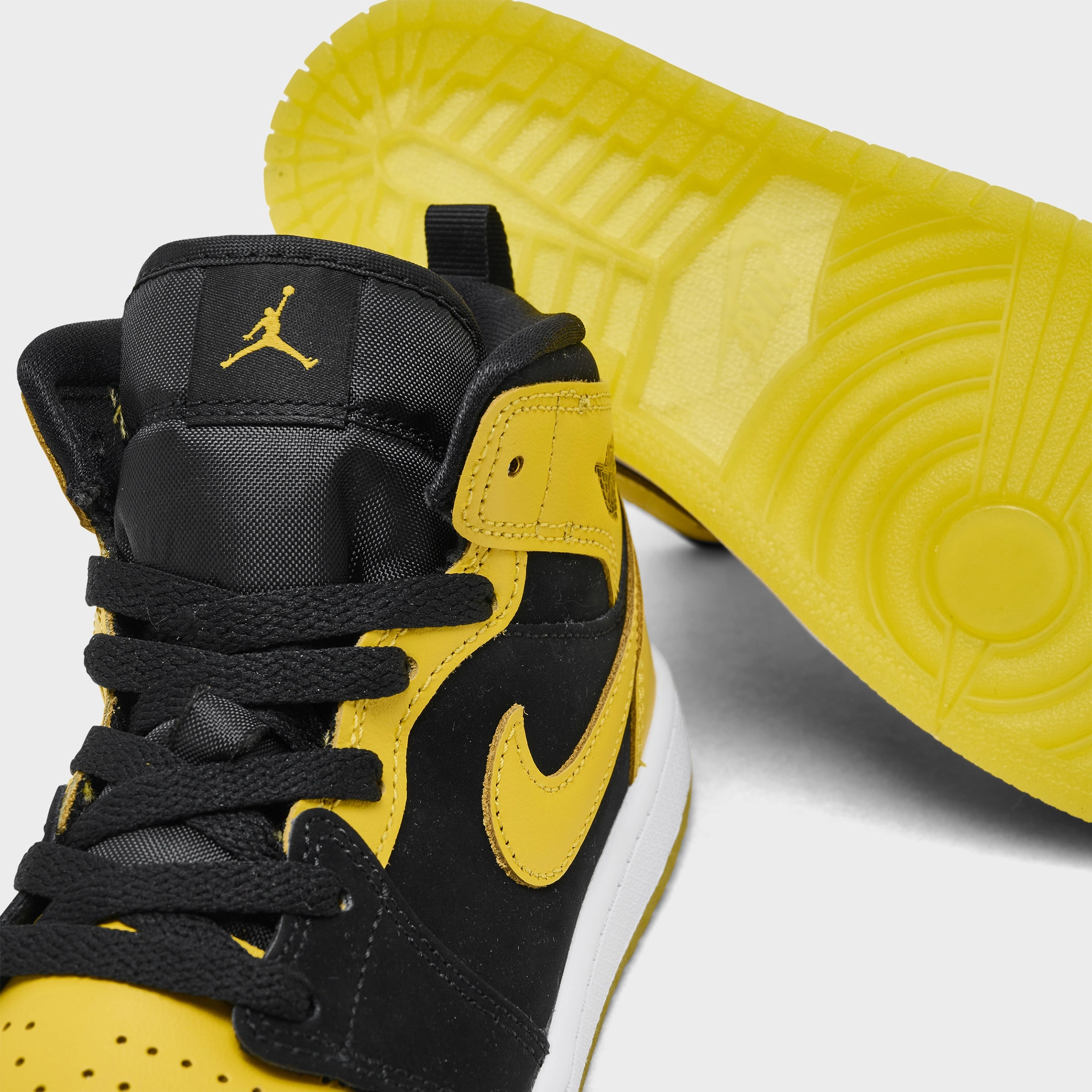 Jordan 1 Mid PS Black / Varsity Maize - White Reactive Energy Transfer Dynamic Traction Pattern